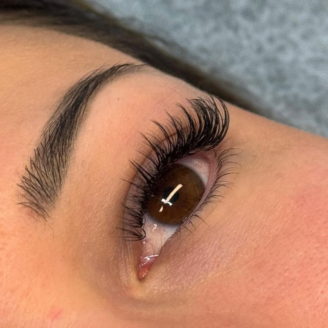 Effortless way to enhance natural beauty, adding length, volume, and definition to the eyes without the need for daily mascara. They offer a customized look, tailored to each client’s eye shape, preferences, and lifestyle.

Different Lash Extension Styles:

✨ Classic Lashes – A timeless, natural enhancement where one extension is applied to each natural lash, creating a soft, mascara-like effect.

✨ Hybrid Lashes – A mix of classic and volume lashes, offering a fuller yet natural appearance with added texture and dimension.

✨ Volume Lashes – Lightweight, ultra-fine lashes are applied in fans, creating a fluffy, dense, and glamorous look while still feeling weightless.

✨ Mega Volume Lashes – For the boldest, most dramatic effect, ultra-thin lashes are applied in dense fans to achieve maximum darkness and fullness.

✨ Wispy Lashes – Inspired by strip lash styles, this look combines varying lash lengths and spikes for a feathery, textured effect.

✨ Doll Eye – Focuses on lengthening the center lashes to open up the eyes, giving a bright and youthful appearance.

✨ Cat Eye – Shorter lashes in the inner corner gradually extend to longer lashes on the outer corner, creating an elegant, elongated eye shape.

✨ Kim K Lashes – A spiky, textured look that mimics celebrity lash styles, adding a bold and trendy effect.

Lash extensions are more than just beauty—they boost confidence, save time on daily makeup, and can be customized to fit any look, from natural to dramatic. Whether someone wants subtle elegance or full-on glam, there’s a lash style to suit every preference!